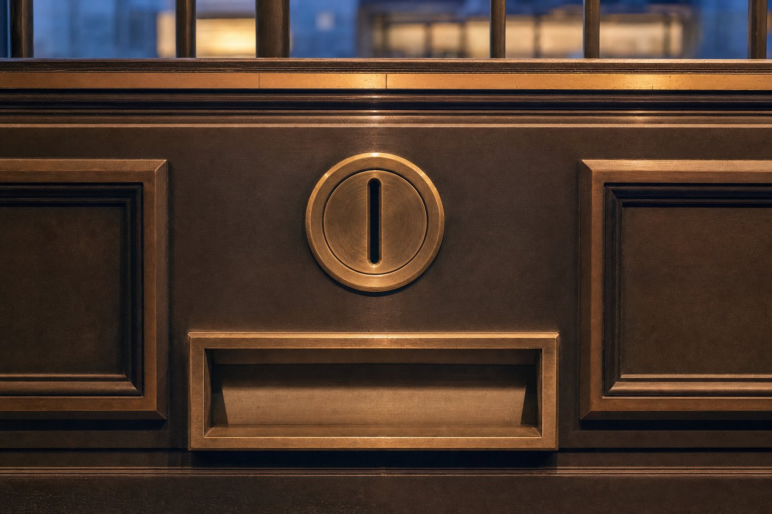 A brass coin slot set into a heavy dark panel, its return tray completely empty